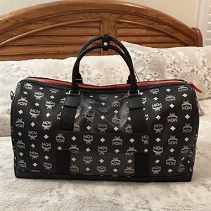 Authentic Black MCM TRAVEL DUFFLE BAG with strap & dust bag in great condition.